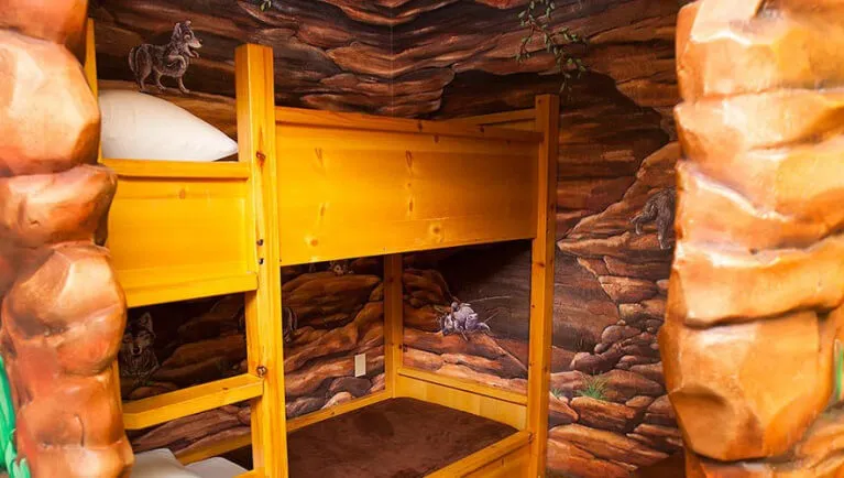 The bunk beds in the indoor cave of the Wolf Den Suite
