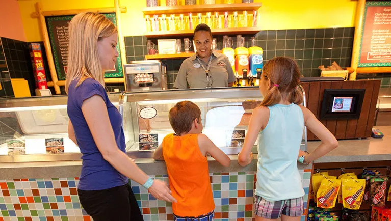 A family of three stand at the ice cream counter 