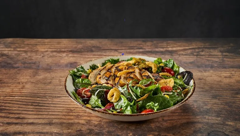 A plate of barbecue chiken salad 