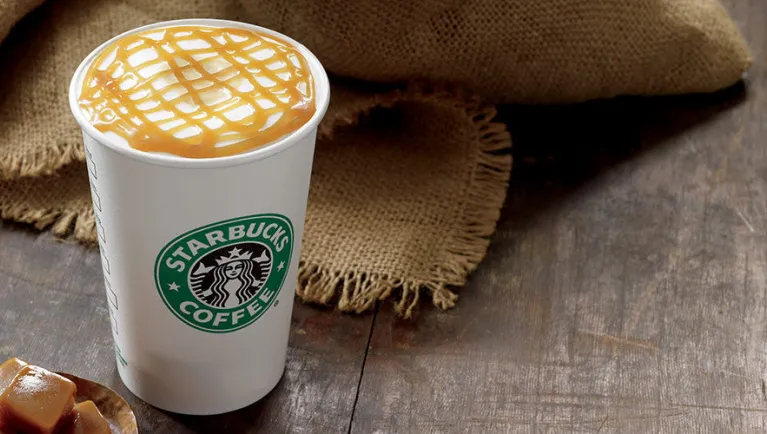 A Starbucks coffee with whip cream and caramel drizzle