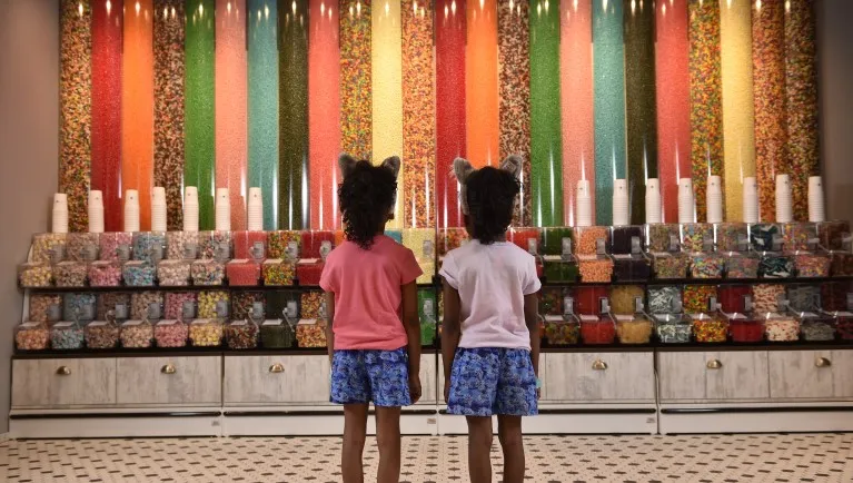 Two girls looking at the candy towers
