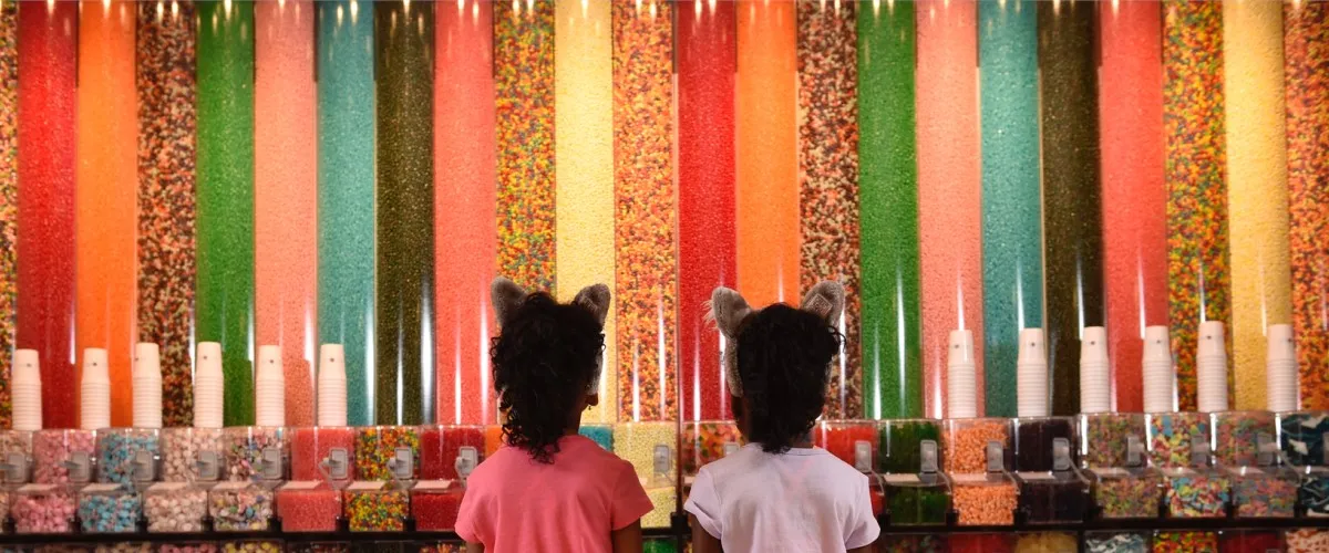 Two girls looking at the candy containers at Great Wolf Lodge