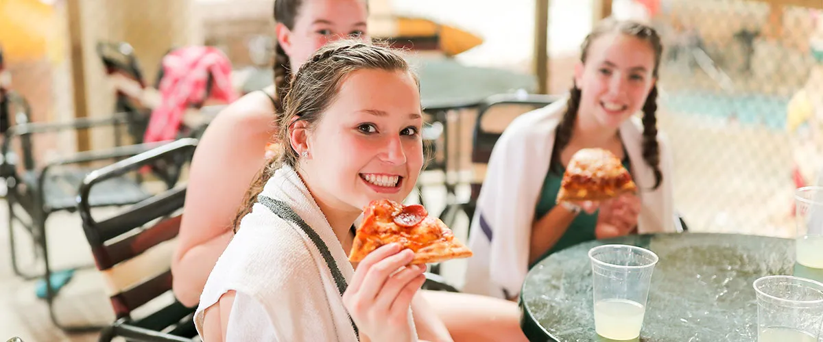 Kids enjoy pizza and drinks in their own private seating at Great Wolf Lodge indoor water park and resort.