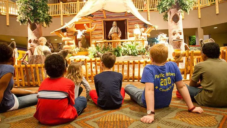 Children sit and watch the Great Clock Tower show