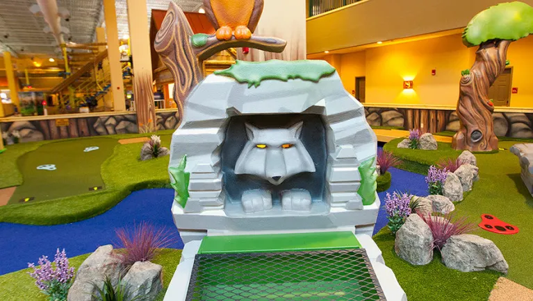 A wolf statue inside Howlin Timbers Play Park at Great Wolf Lodge indoor water park and resort.