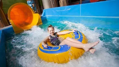 The child rides a tube down the Rapid Racer ride at Great Wolf Lodge indoor water park and resort.