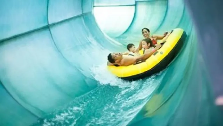 A family of four ride a tube down Great Wolf Lodge’s Double Whirlwind.
