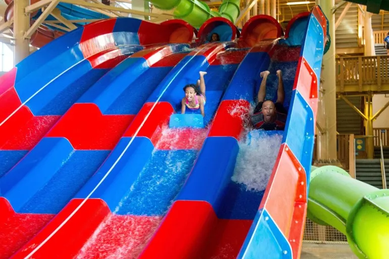A girl closes her eyes as she finishes the Mountain Edge Raceway water slide