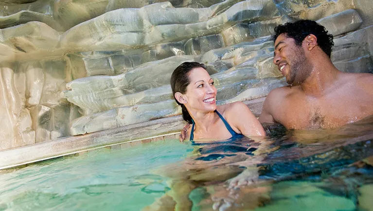 A couple smiles at each other  in the North Hot Springs