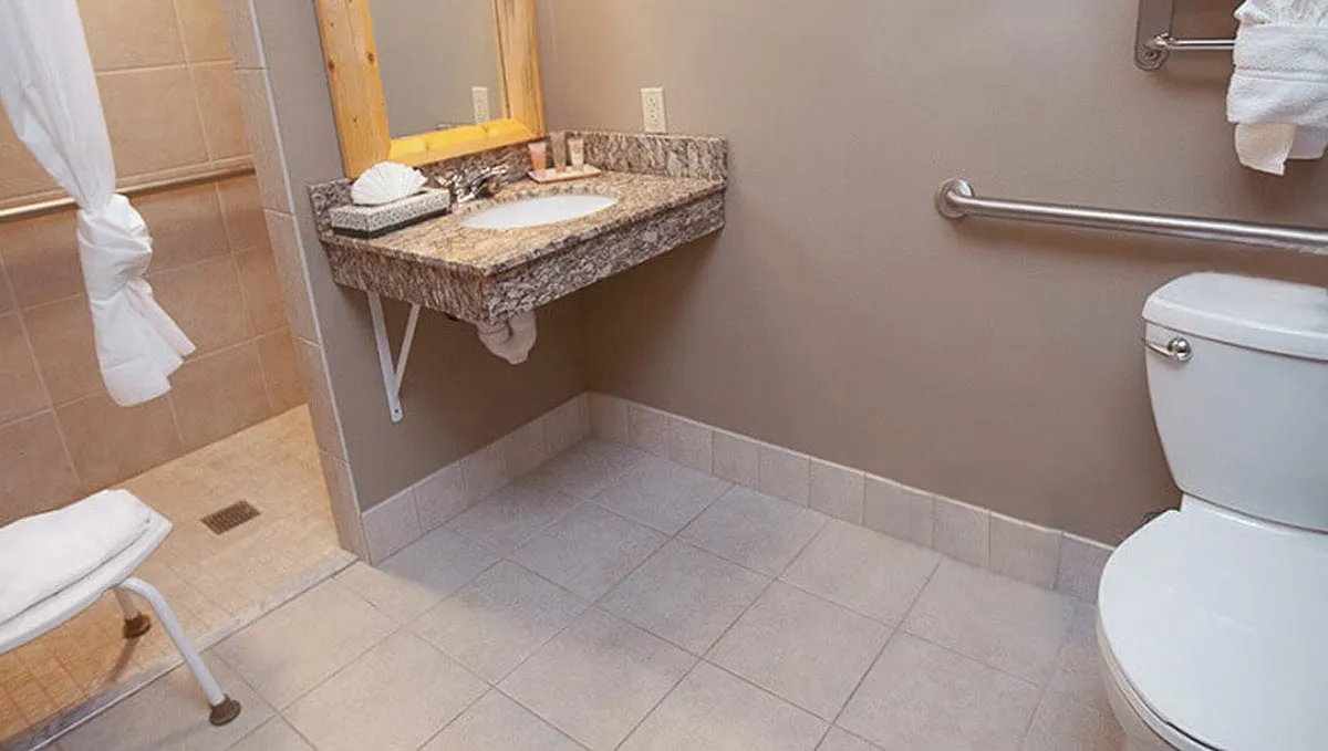 The bathroom in the accessible shower Queen Sofa Suite